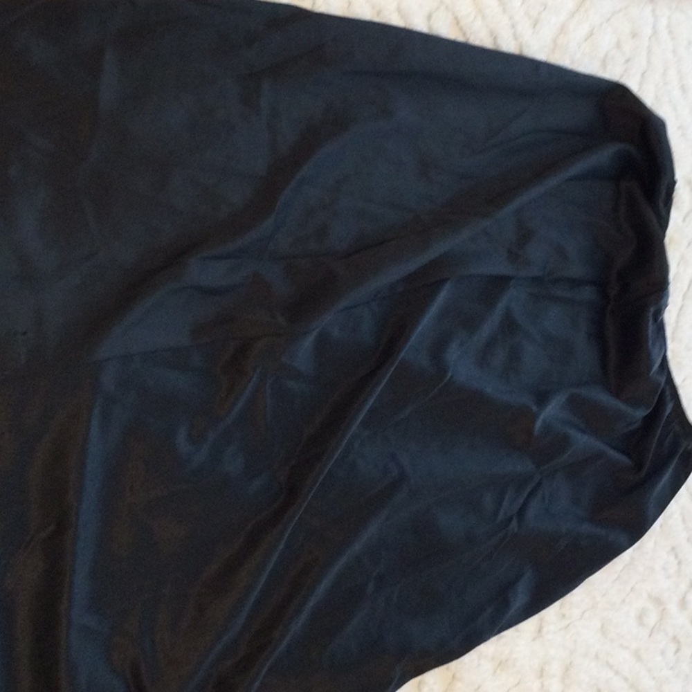 Long black slip with slit. 39 1/4 inches in length.